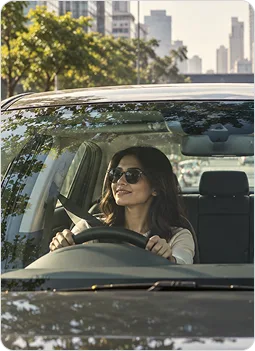 Woman driving car smiling